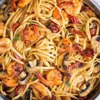 Mushroom Garlic Shrimp Pasta in a mildly spiced buttery sauce is light and loaded with flavour. Caramelized mushrooms, Juicy shrimps, Sundried tomatoes, all these goodness in one pan, makes it a  perfect meal on any occasion. 