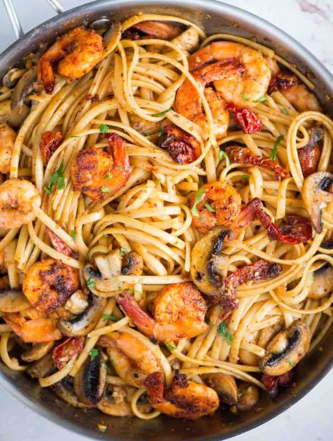Mushroom Garlic Shrimp Pasta in a mildly spiced buttery sauce is light and loaded with flavour. Caramelized mushrooms, Juicy shrimps, Sundried tomatoes, all these goodness in one pan, makes it a  perfect meal on any occasion. 