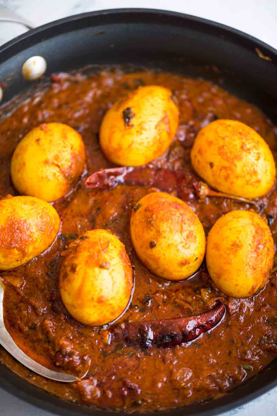 Egg Curry is a deliciously rich onion tomato gravy, tastes exactly like the ones you get in dhabas. These are perfect with some rice or paratha and fresh salad on the side.