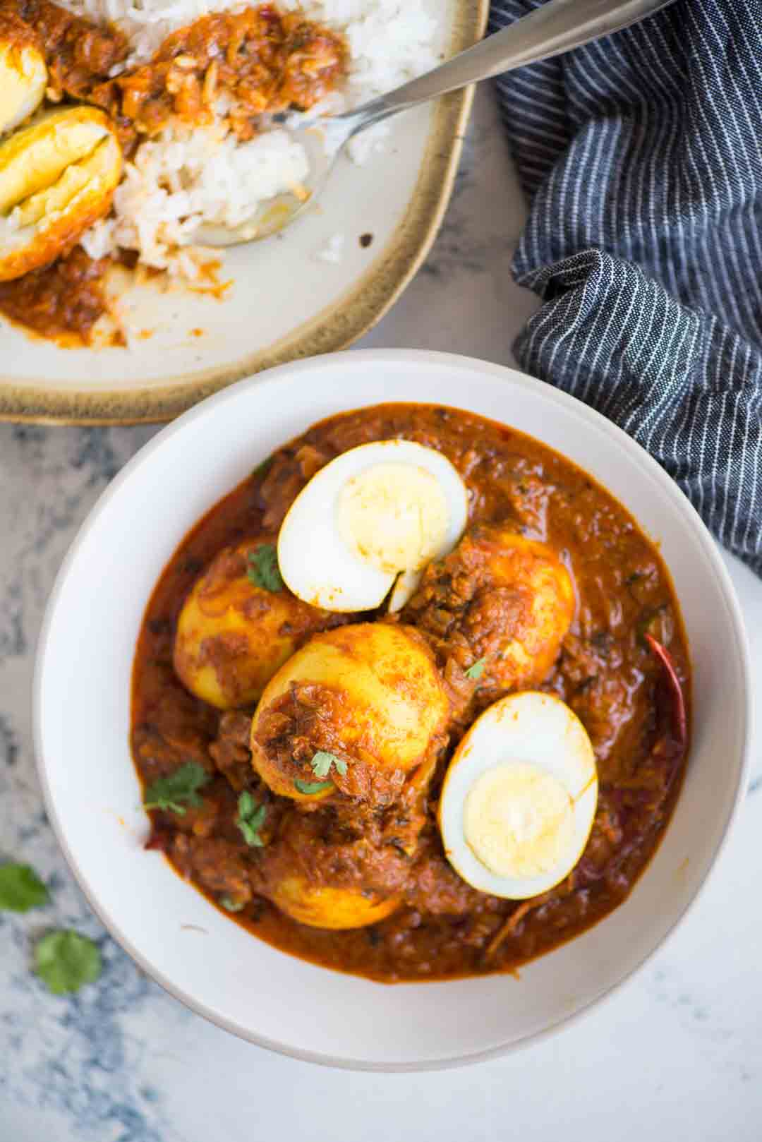 Egg Curry is a deliciously rich onion tomato gravy, tastes exactly like the ones you get in dhabas. These are perfect with some rice or paratha and fresh salad on the side.