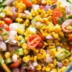 Fresh Roasted Corn Salad is packed with sweet corns, cucumber, tomato, onion and tossed in a lemony vinaigrette. Charred corn ads a lot of flavour to the salad. This quick salad is a perfect side dish in summer BBQs or for potlucks. 