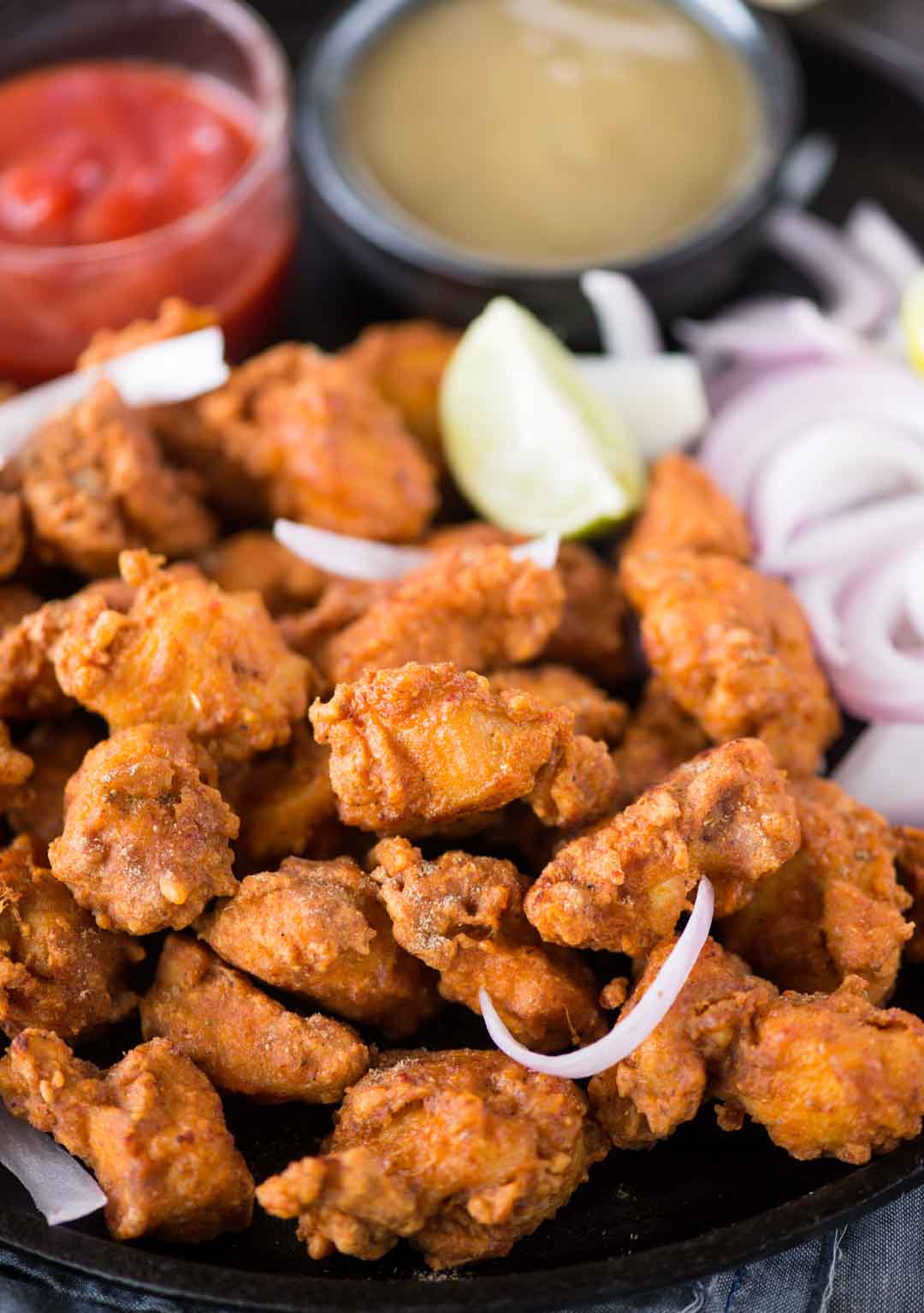 Seriously addictive Chicken pakora is a crowd pleasure in any party. Chicken coated in a thick spicy batter, fried until crispy and tastes exactly like street style. 