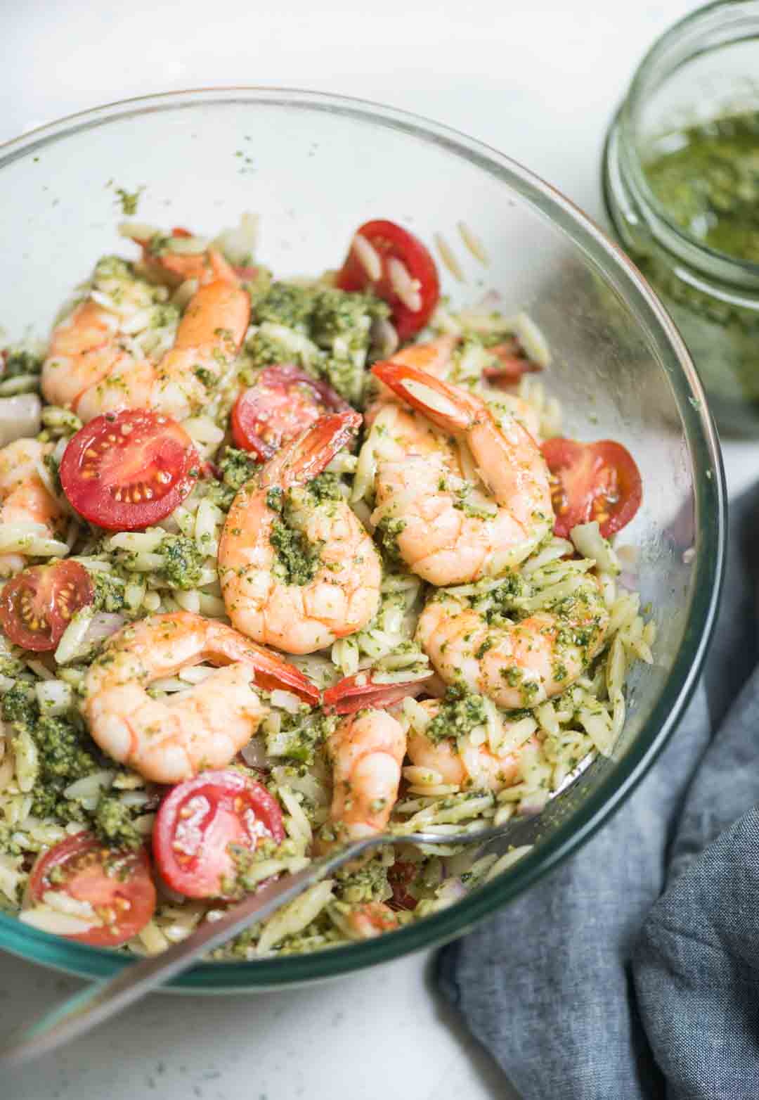 Orzo salad is loaded with Juicy shrimp, cherry tomatoes, onion and everything is tossed in fresh basil pesto. This refreshing salad can be served as a main dish or as a side dish in summer barbeque.
