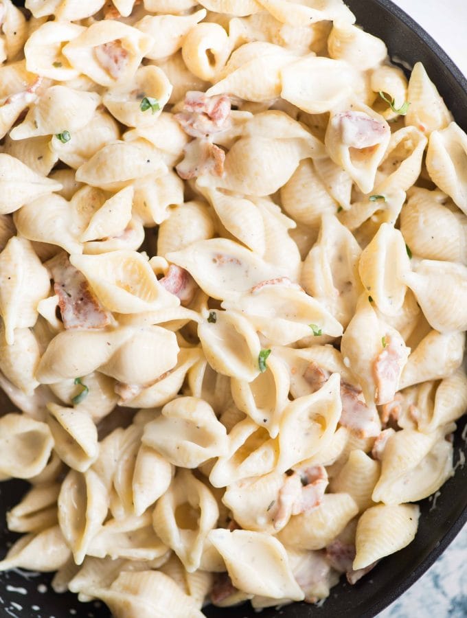 A quick and easy Shell pasta dish in a garlic cream cheese sauce and bacon. Utterly delicious !! This small shell pasta dish can be made in less than 30 minutes. With some wine or protein as sides, this makes a tasty lunch or dinner.