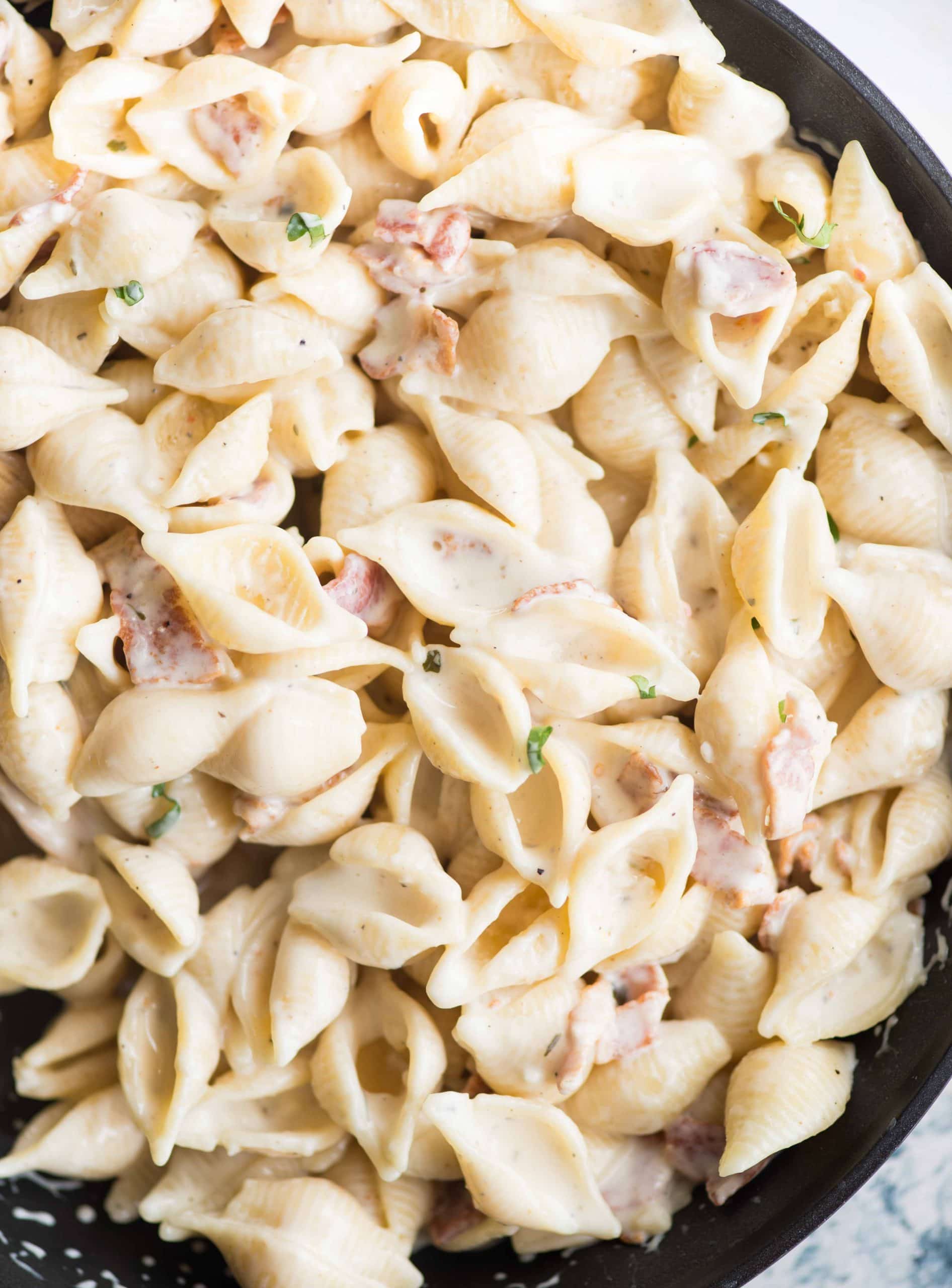 A quick and easy Shell pasta dish in a garlic cream cheese sauce and bacon. Utterly delicious !! This small shell pasta dish can be made in less than 30 minutes. With some wine or protein as sides, this makes a tasty lunch or dinner.