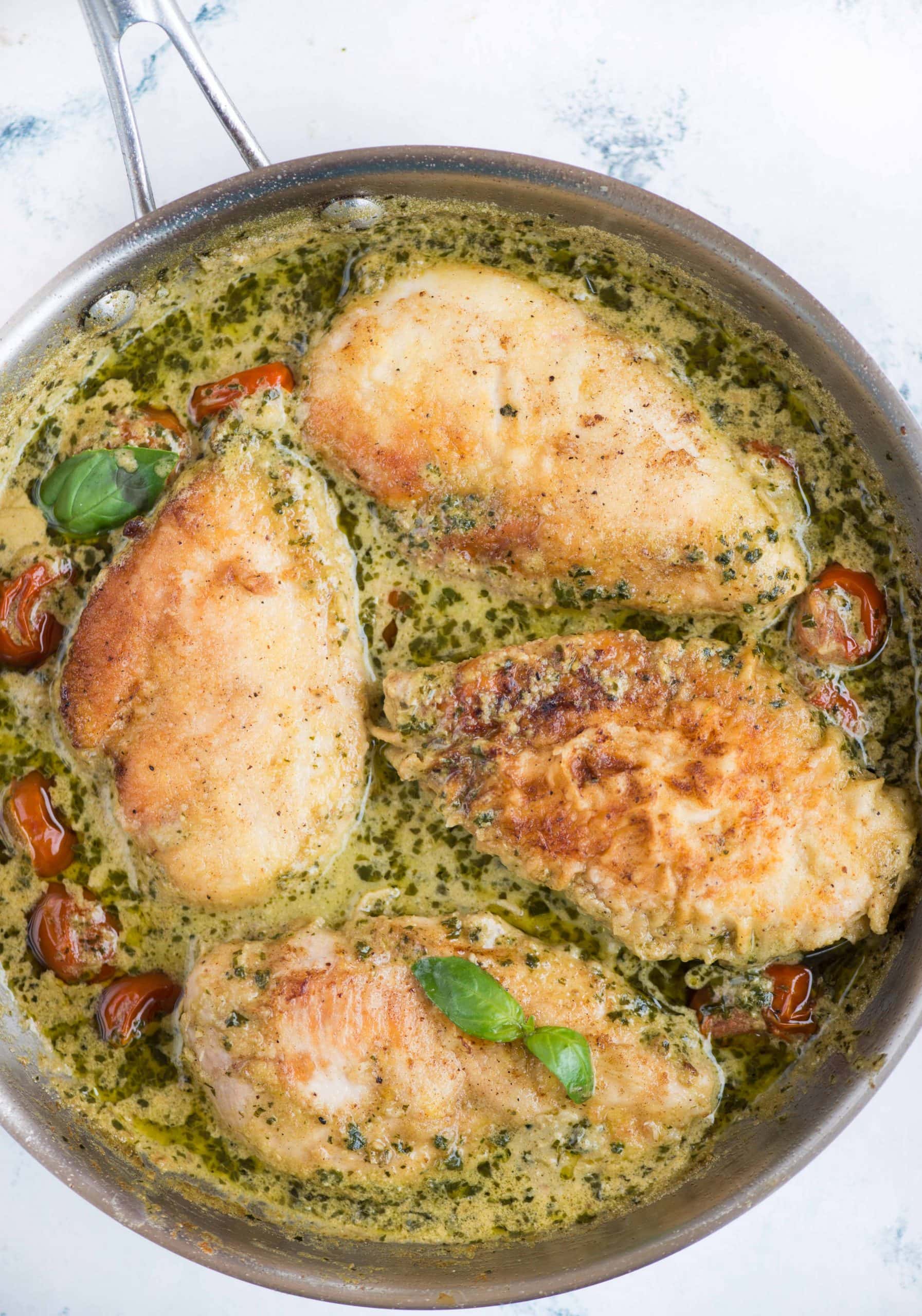 Pesto Chicken in a light and creamy sauce is packed with flavor that takes less than 30 minutes to make. Toss some pasta in the sauce and a delicious dinner is on the table in no time. 