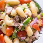 Close up view of cold tuna pasta salad served in a glass salad.
