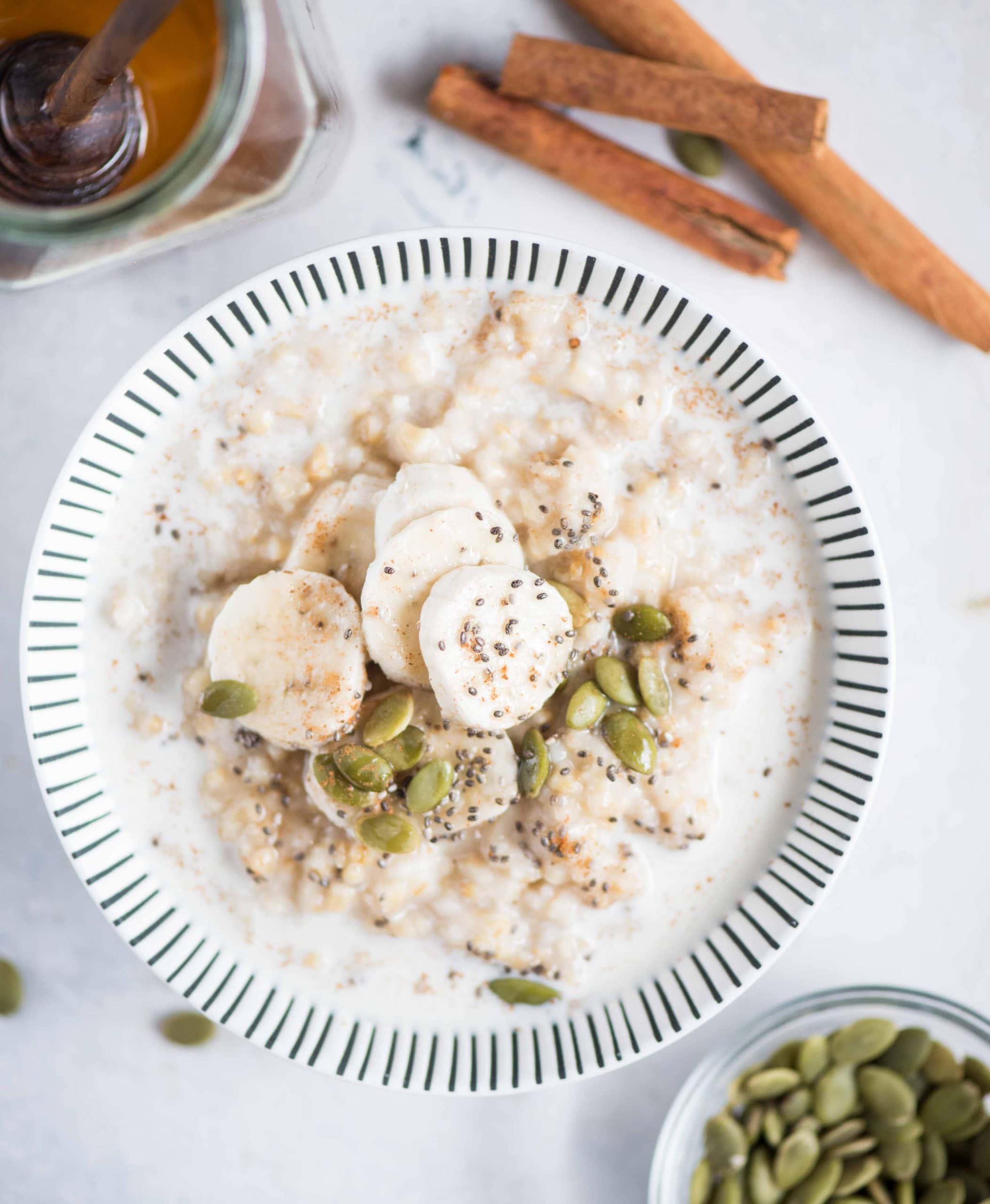 Instant pot Steel cut oats topped with banana, seeds, maple syrup and a pinch of cinnamon. 