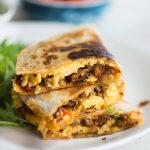 Crispy Tortilla filled with soft scrambled eggs, cheese, breakfast sausage, and bacon, Breakfast quesadilla is easy and quick to make. These quesadillas are perfect for breakfast, brunch, or even dinner.