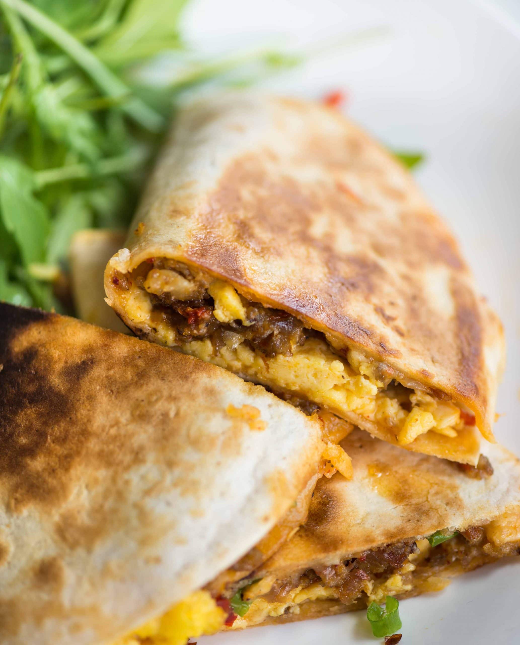 Crispy Tortilla filled with soft scrambled eggs, cheese, breakfast sausage, and bacon, Breakfast quesadilla is easy and quick to make. These quesadillas are perfect for breakfast, brunch, or even dinner.