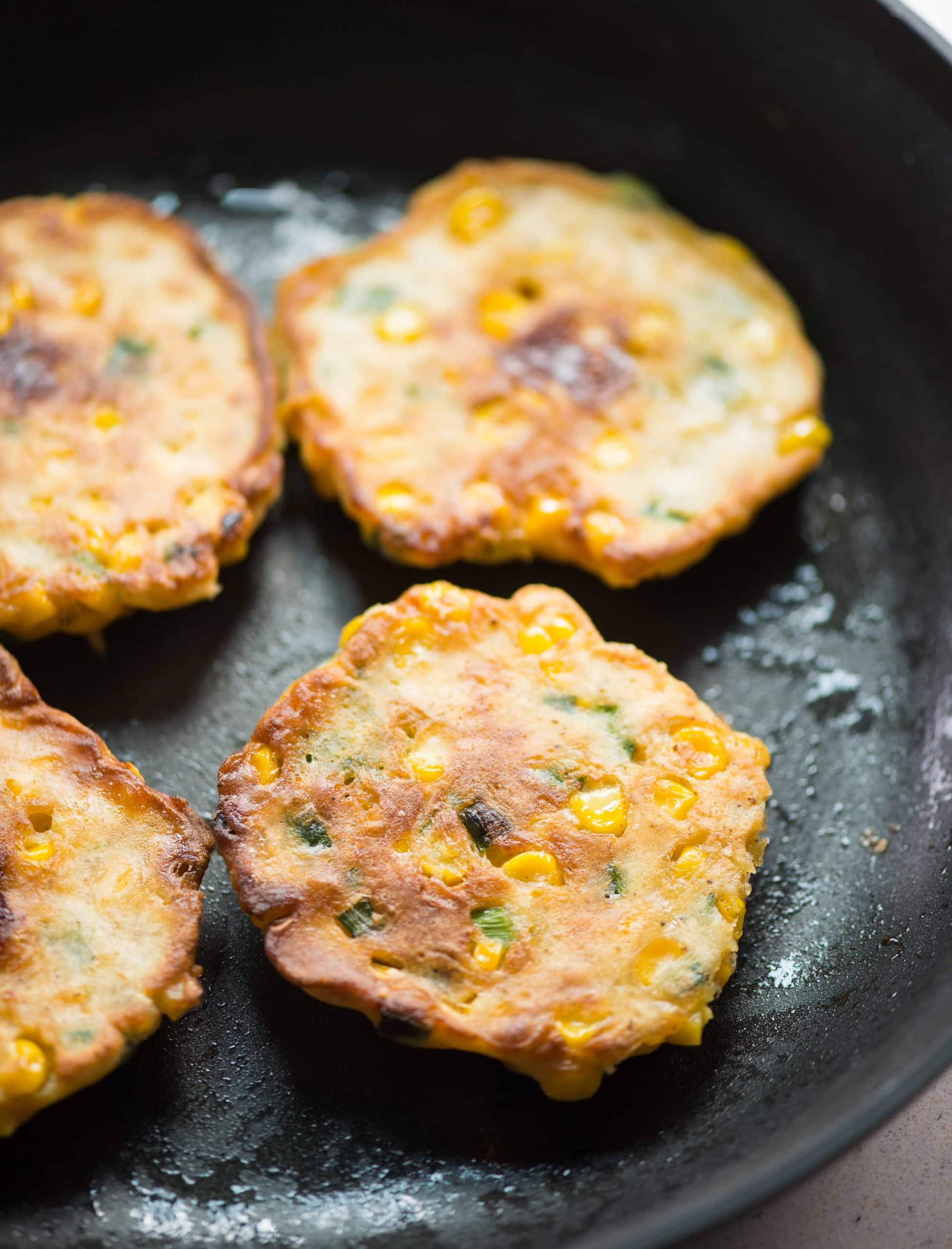 Freshly fried corn fritters on a pan