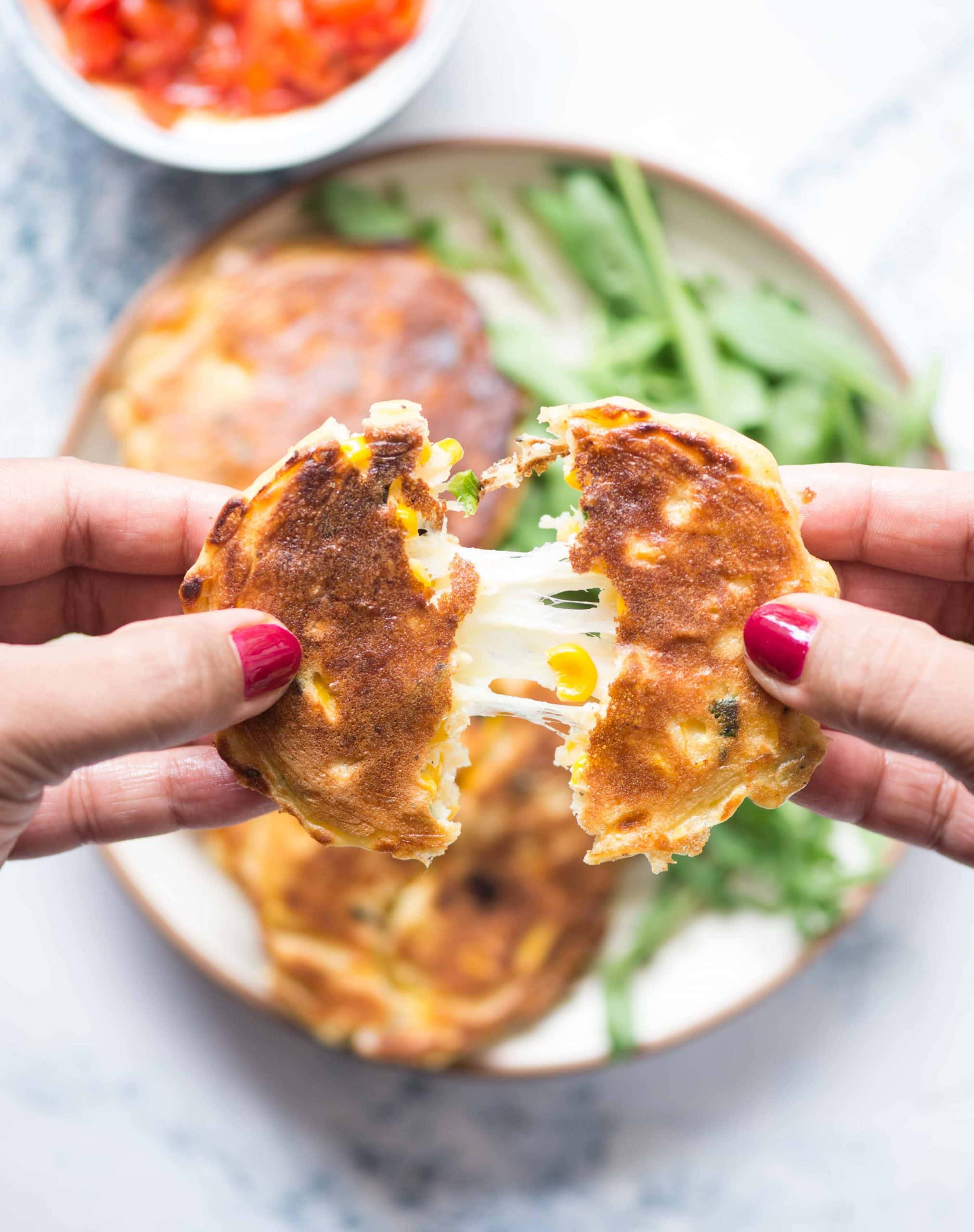 Corn fritters with gooey cheese in the middle