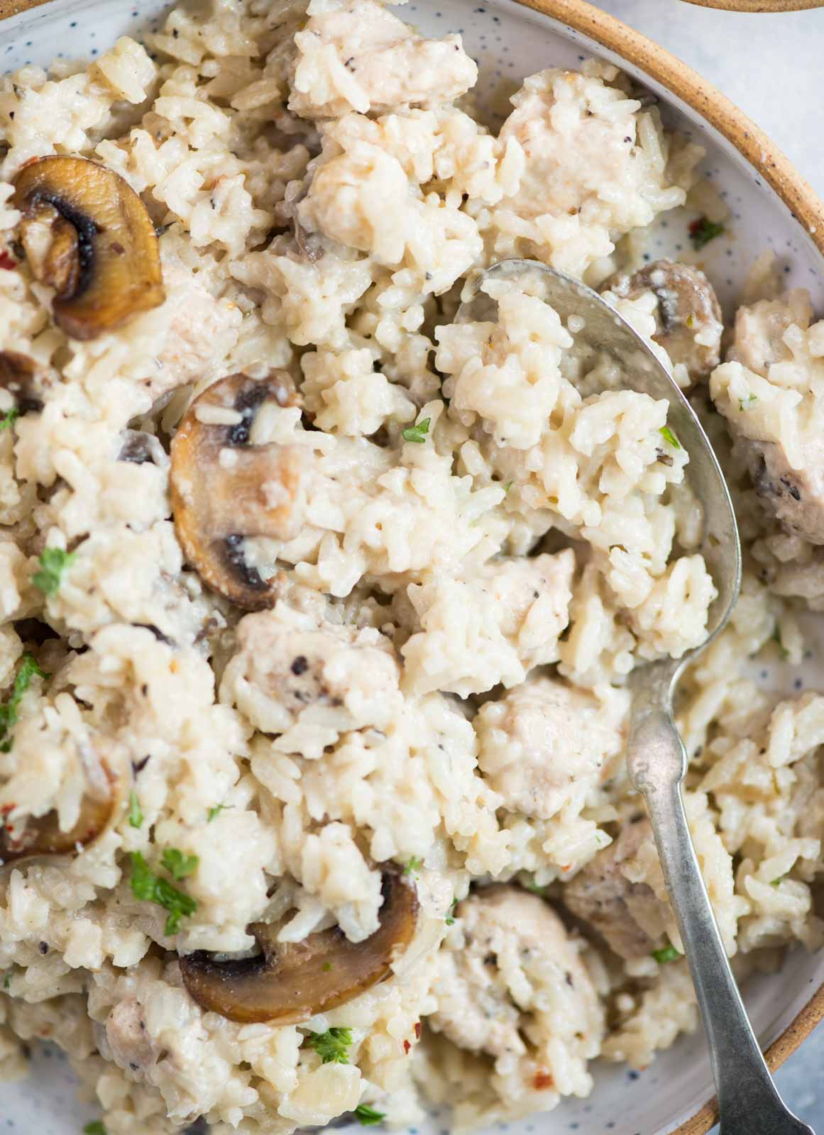 Creamy Chicken and rice with roasted mushrooms is a one-pot dinner that is hearty and comforting. Caramelized mushroom adds so much flavour to the dish and makes a perfect family-friendly dinner. 