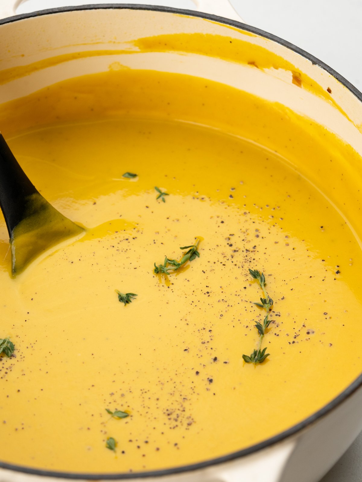 simple homemade pumpkin soup with freshly crushed black pepper and thyme.