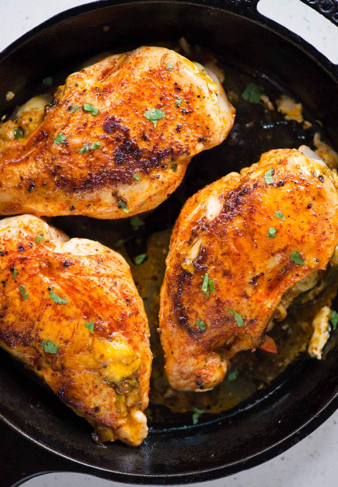 Three chicken breasts with fajita-stuffing, which is made of caramelized and crunchy peppers, onion, Mexican seasoning, and cheese, then baked to perfection on a  skillet. 