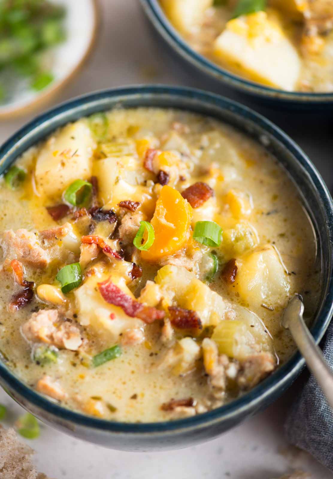 Instant Pot Potato Soup with sausage has tender soft potato, Italian sausage in a creamy yet light, and flavorful broth. Serve this gluten-free soup with a generous topping of crispy bacon and cheese. 
