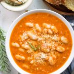 This Tomato White Bean soup with tangy tomatoes, white beans, parmesan is super satisfying and takes less than 30 minutes to make.
