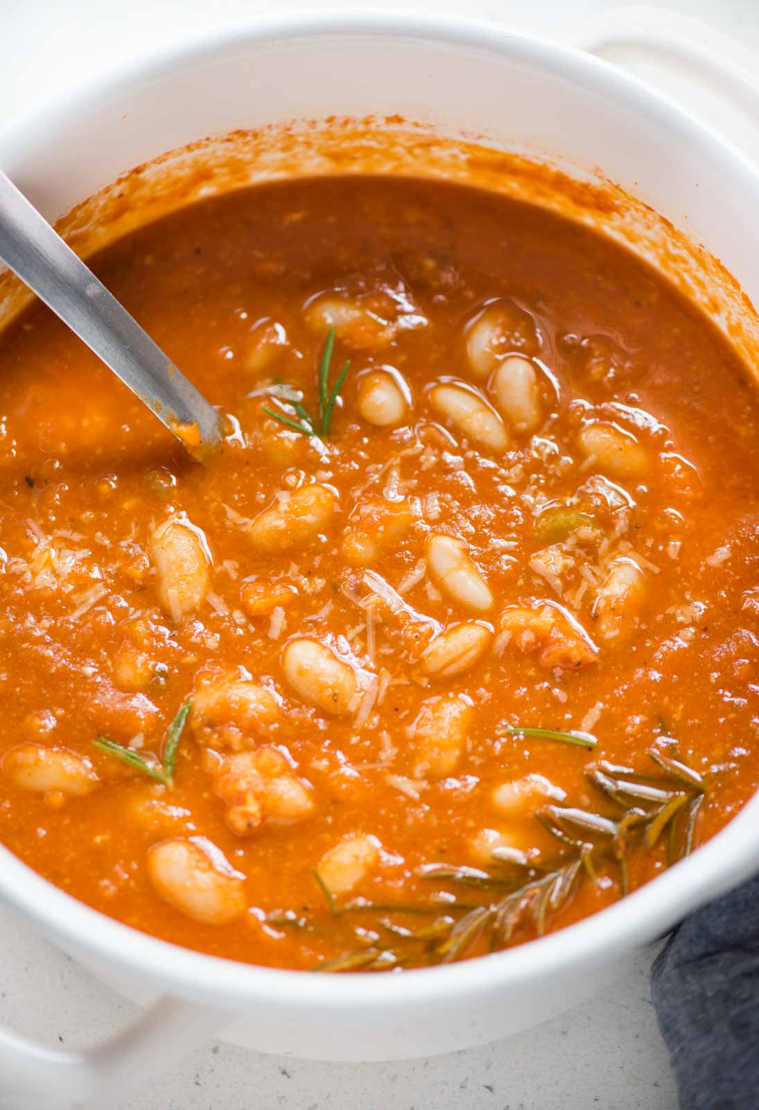 Tomato White Bean soup with tangy tomatoes, white beans, parmesan is cooked in dutch oven under 30 minutes. 