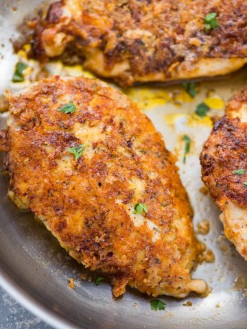 Perfectly crispy Parmesan Crusted Chicken recipe is an easy low carb chicken dinner made in just 15 minutes. Chicken coated with mayo for extra moist chicken, breaded with parmesan, and pan-fried.
