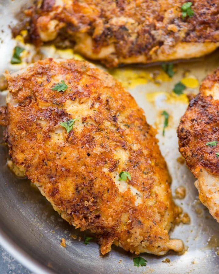 Perfectly crispy Parmesan Crusted Chicken recipe is an easy low carb chicken dinner made in just 15 minutes. Chicken coated with mayo for extra moist chicken, breaded with parmesan, and pan-fried.