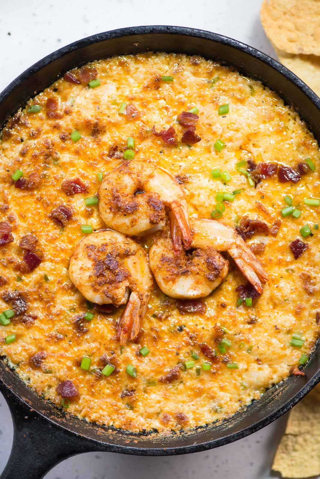 cheesy hot Shrimp Dip with Bacon with juicy shrimp and three types of cheese made in a cast iron pan