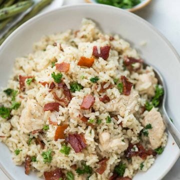 Instant Pot Ranch chicken and rice with crispy bacon is a one-pot dinner. Juicy chicken breast and rice, perfectly seasoned with ranch seasoning.