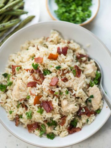 Instant Pot Ranch chicken and rice with crispy bacon is a one-pot dinner. Juicy chicken breast and rice, perfectly seasoned with ranch seasoning.