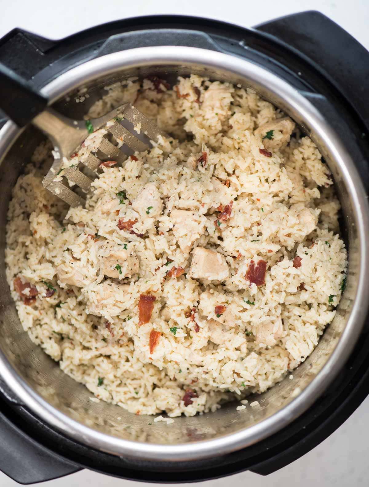 Instant Pot Ranch chicken and rice with crispy bacon is a one-pot dinner.  Juicy chicken breast and rice, perfectly seasoned with ranch seasoning. 