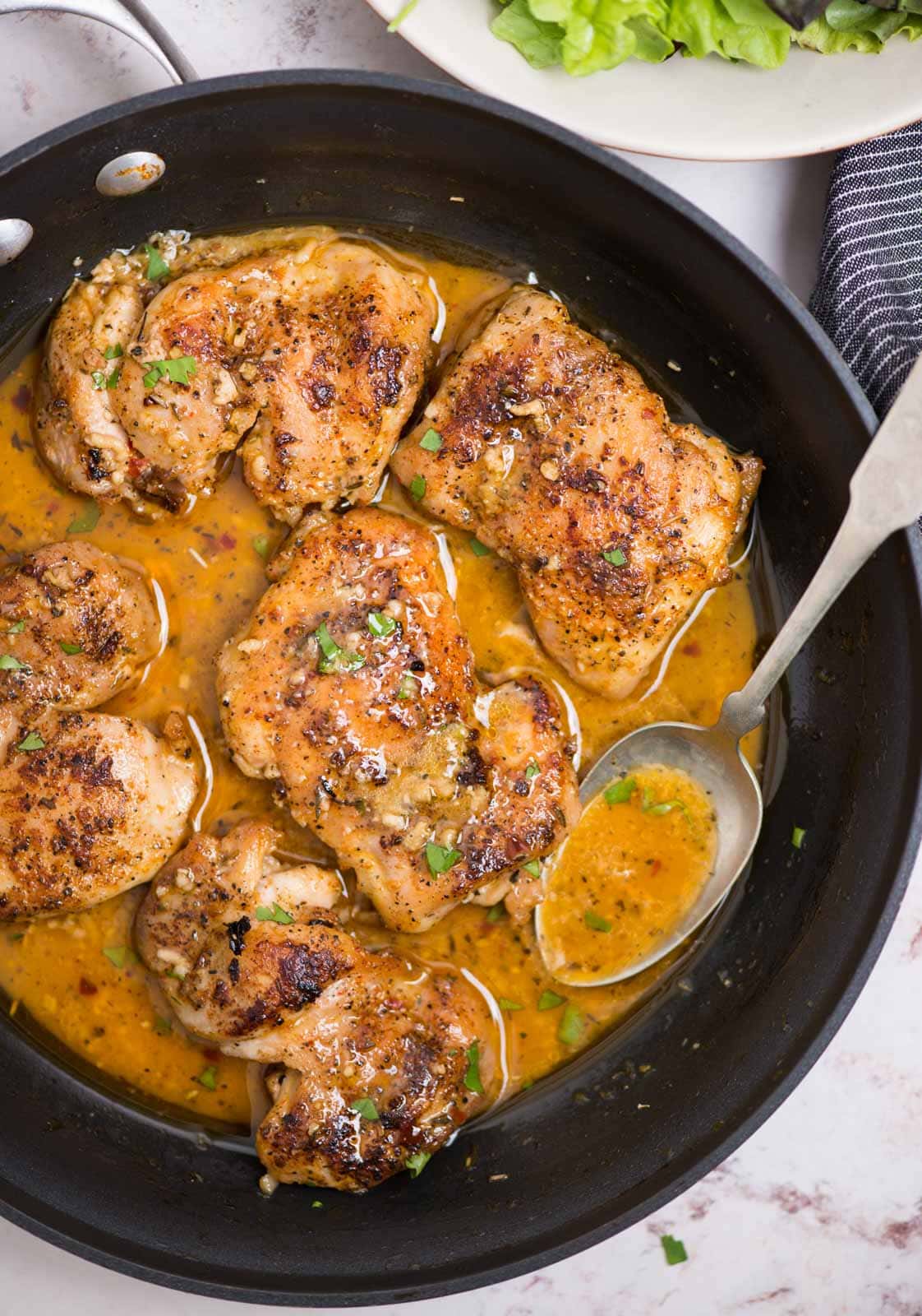 Juicy tender Boneless skinless chicken thighs in butter garlic sauce is crazy delicious. The garlic butter sauce has no cream, no flour yet is so creamy. Make this easy dinner on the stovetop in just 30 minutes. 