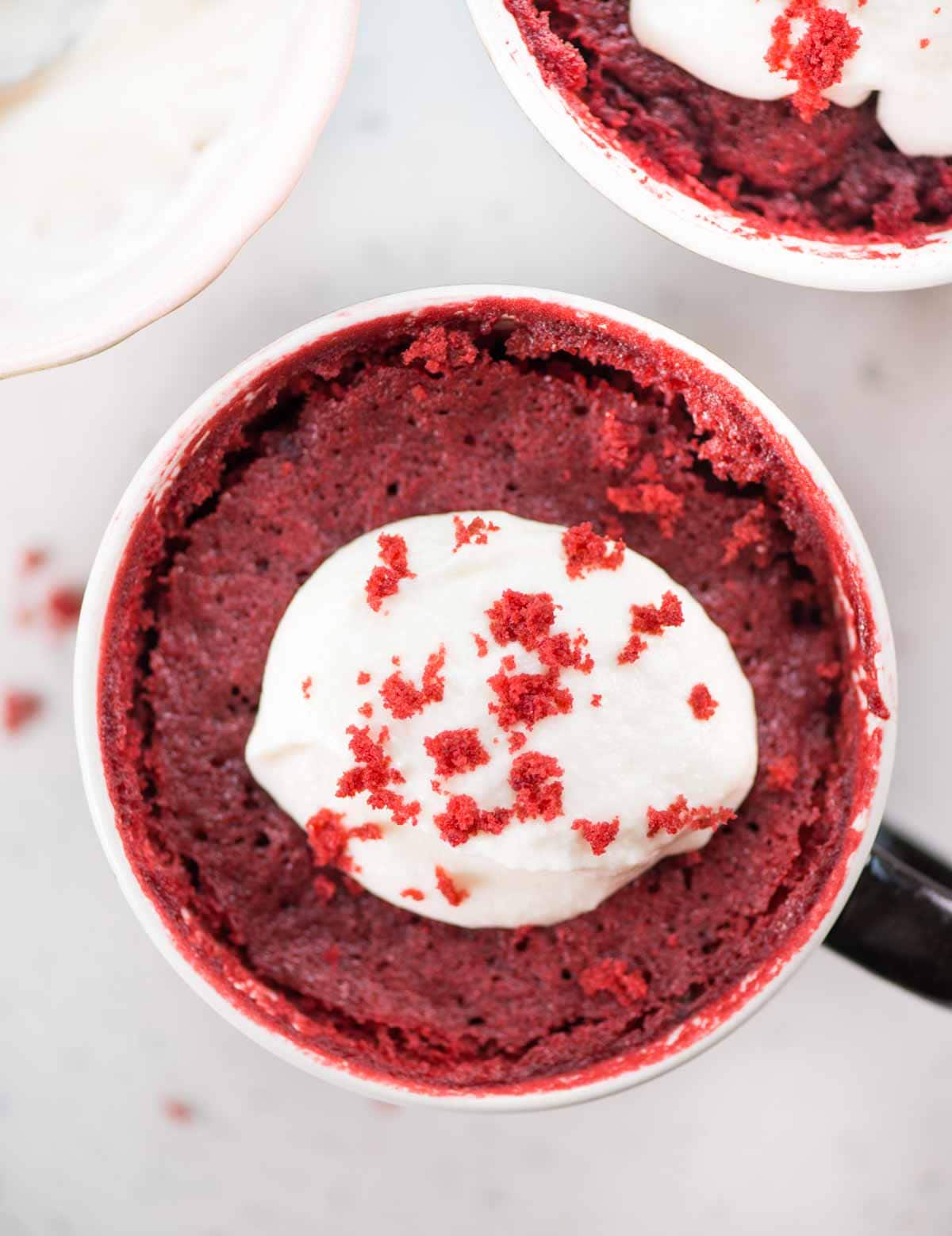 This Red Velvet Mug Cake is airy, ultra moist, and tastes just like the regular oven-baked red velvet cake. Topped with cream cheese frosting, this eggless microwave mug cake is ready in less than 10 minutes.