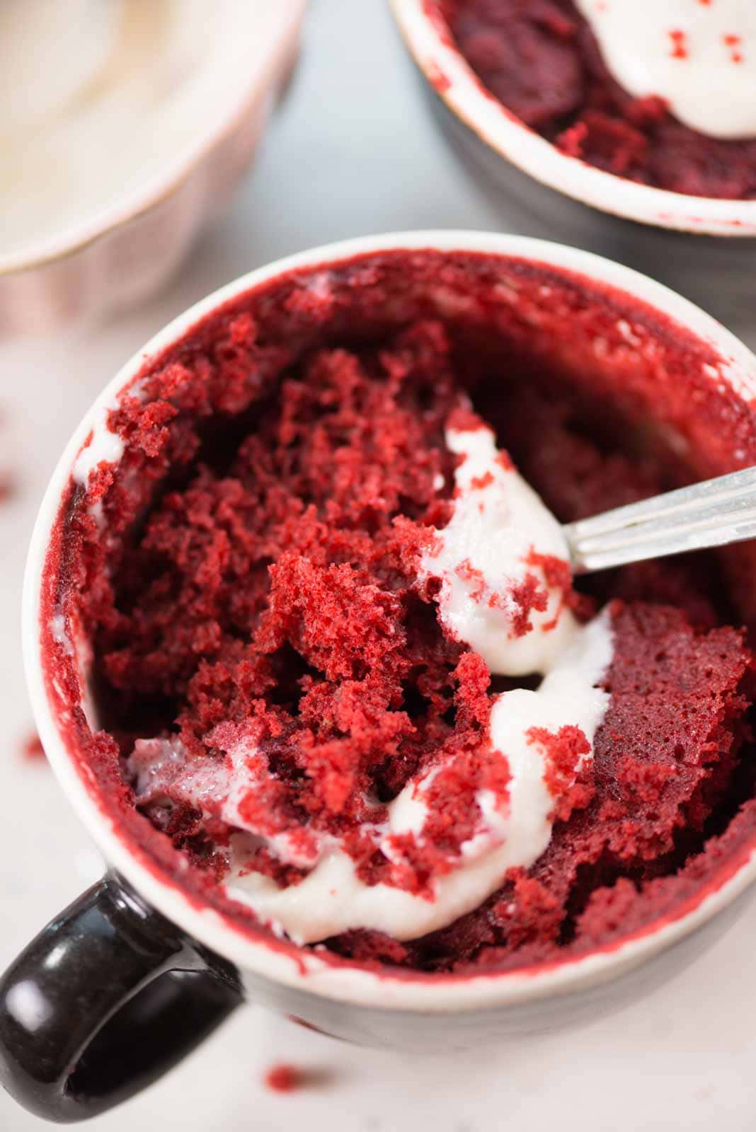 This Red Velvet Mug Cake is airy, ultra moist, and tastes just like the regular oven-baked red velvet cake. Topped with cream cheese frosting, this eggless microwave mug cake is ready in less than 10 minutes.