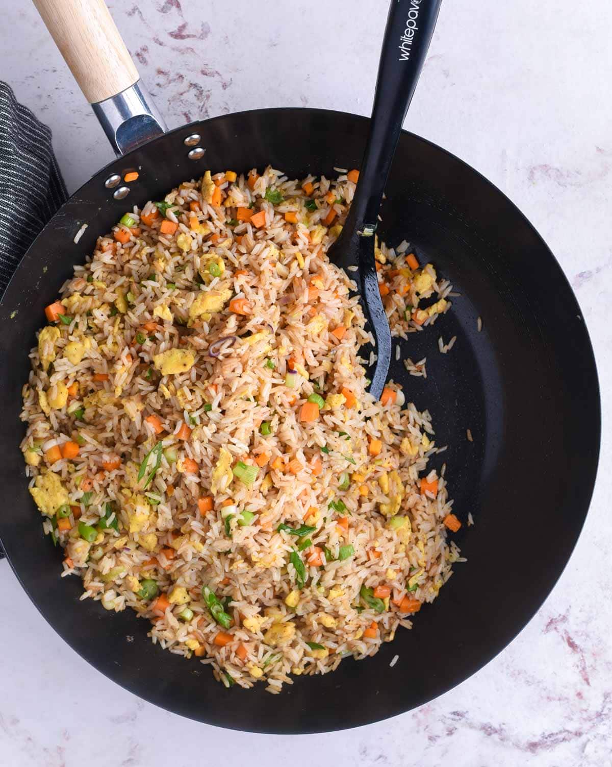day old rice, veggies and sauce tossed in a wok to make the best egg fried rice ever 