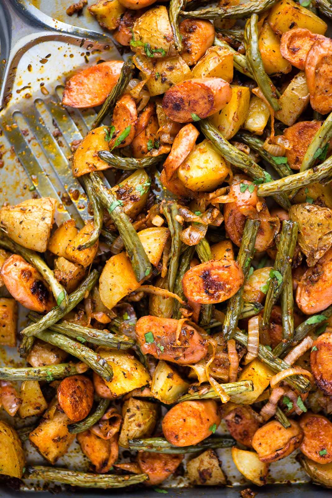 Sausage and potatoes- This super easy and delicious dinner is cooked in a Sheet pan with 10 minutes prep. Potatoes, sausage, green beans, and onion are tossed in a buttery dressing and baked to perfection. 