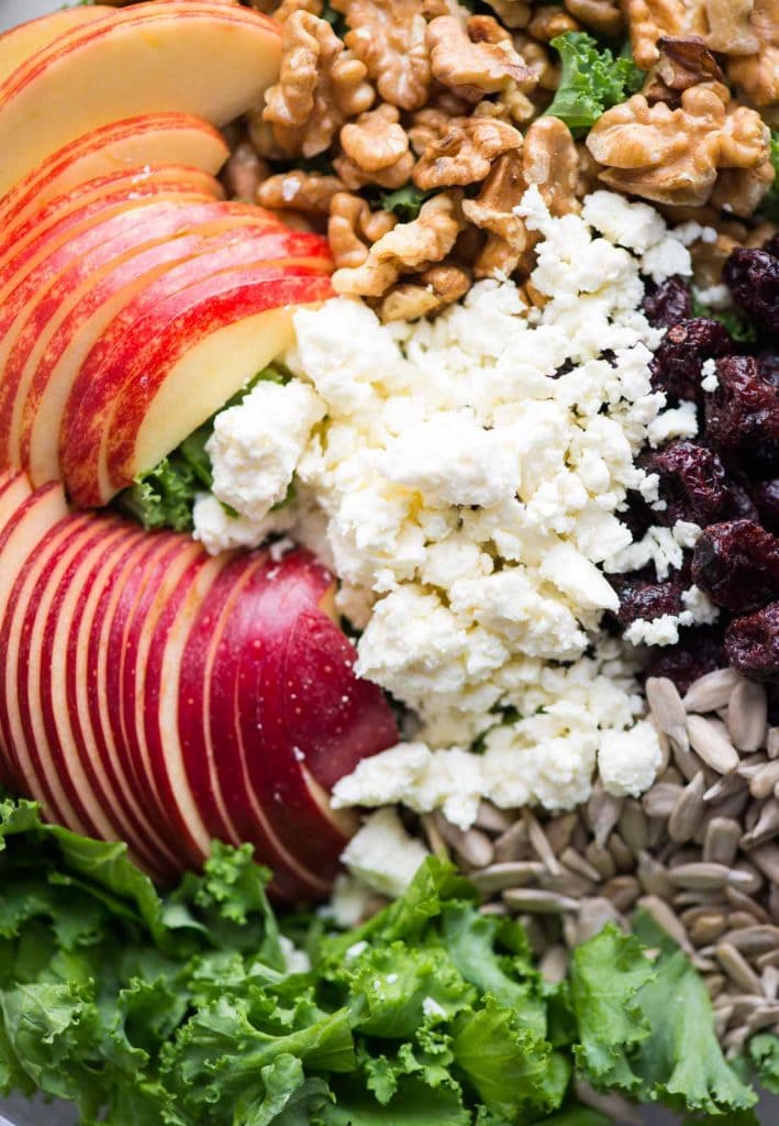 Assebling apple kale salad.