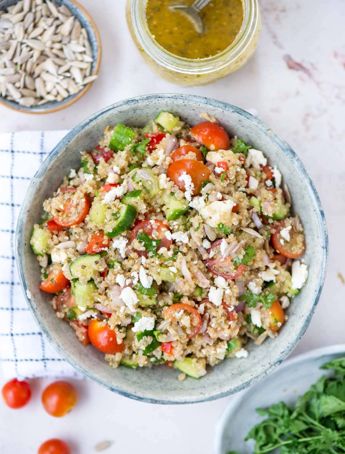 Bowl of Quinoa salad with fresh vegetables, herbs in a red wine vinaigrette