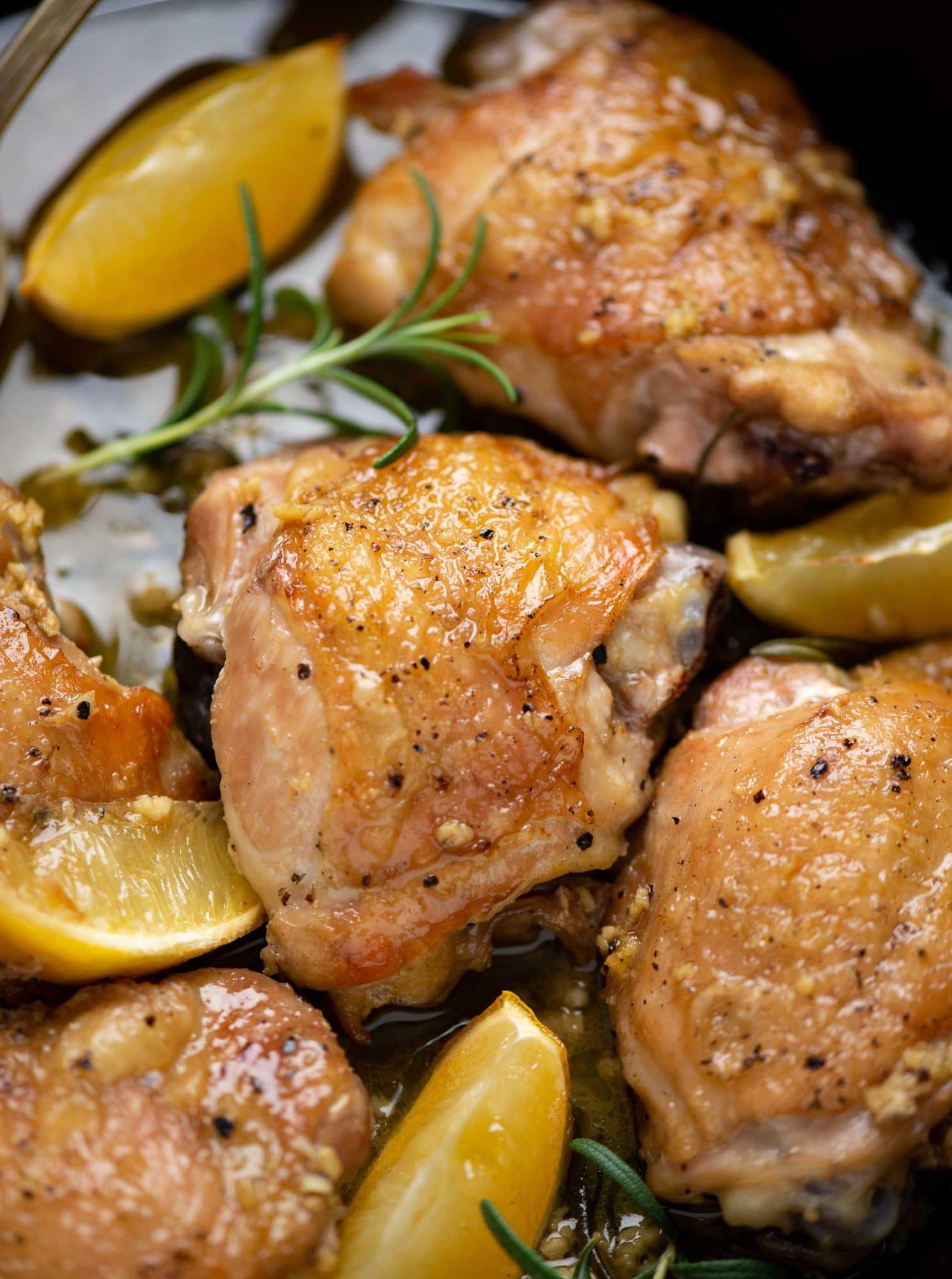 Baked chicken thighs with a crispy skin made in lemon garlic sauce and rosemary infused flavors.