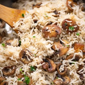 Close-up shot of Mushroom rice with brown sauteed bits of mushroom and garnished with parsley