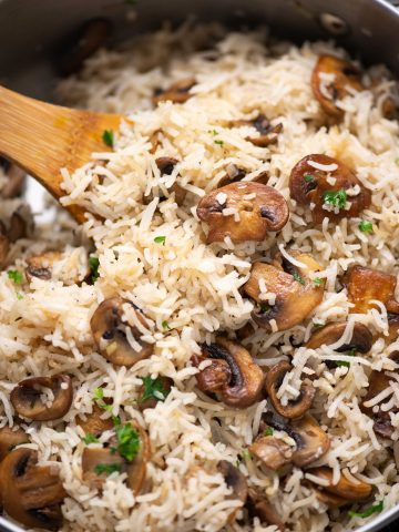 Close-up shot of Mushroom rice with brown sauteed bits of mushroom and garnished with parsley
