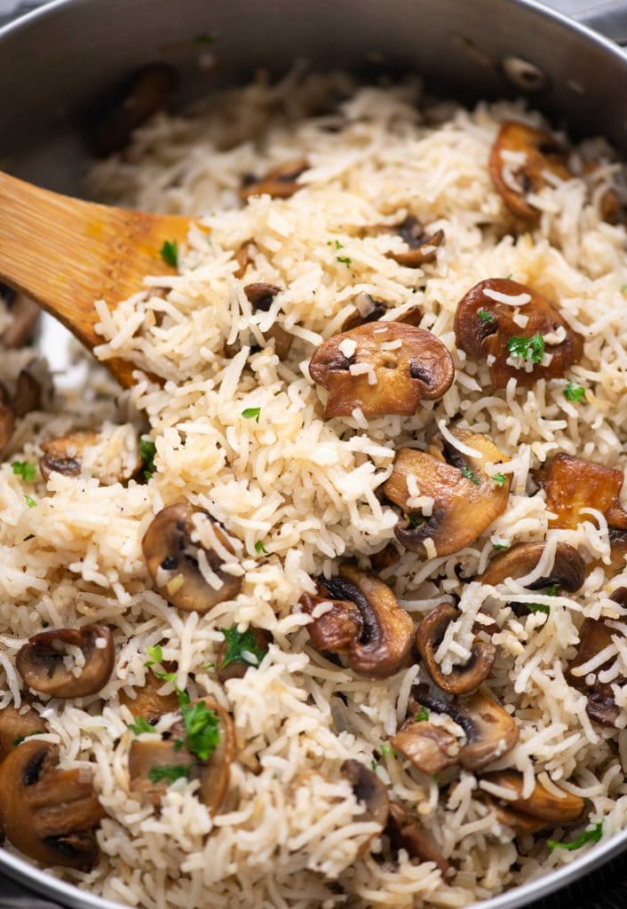 Close-up shot of Mushroom rice with brown sauteed bits of mushroom and garnished with parsley