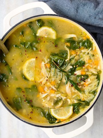 Chicken orzo soup served in a bowl and made with orzo, chicken and fresh herbs and lemon juice.