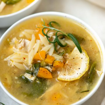 Chicken orzo soup served in a bowl and made with orzo, chicken and fresh herbs and lemon juice.