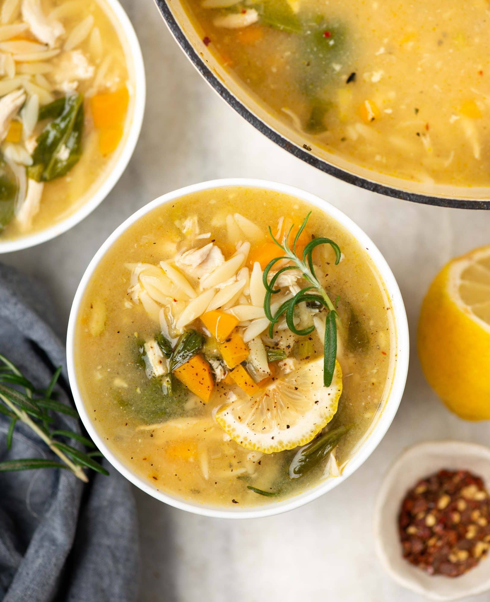 Chicken orzo soup served in a bowl and made with orzo, chicken and fresh herbs and lemon juice.