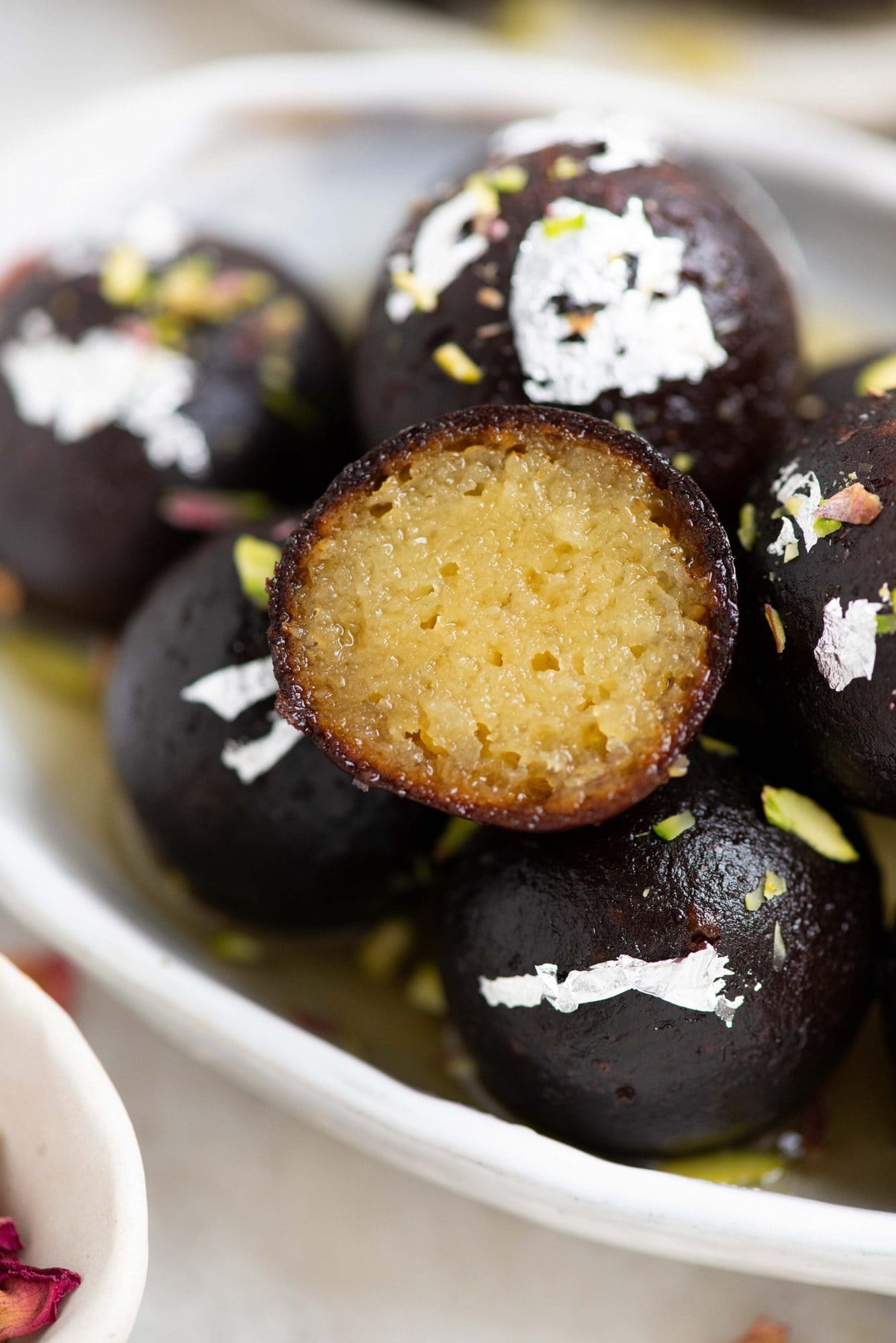 closeup picture of a split kala jamun showing the juicy soft core