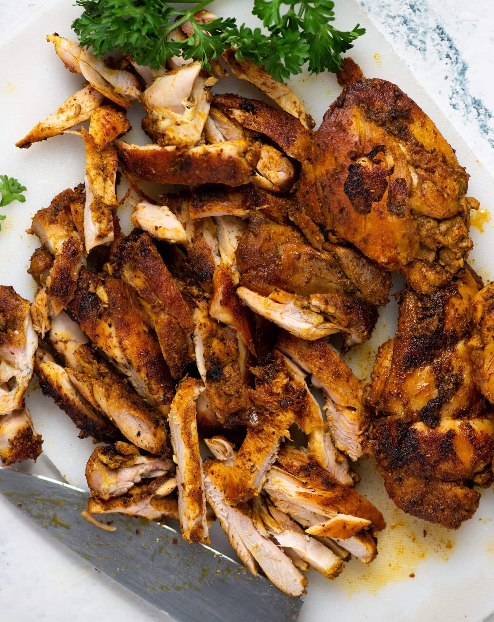 Chicken thighs grilled with spices and cut into thin pieces to be added as stuffing chicken shawarma.