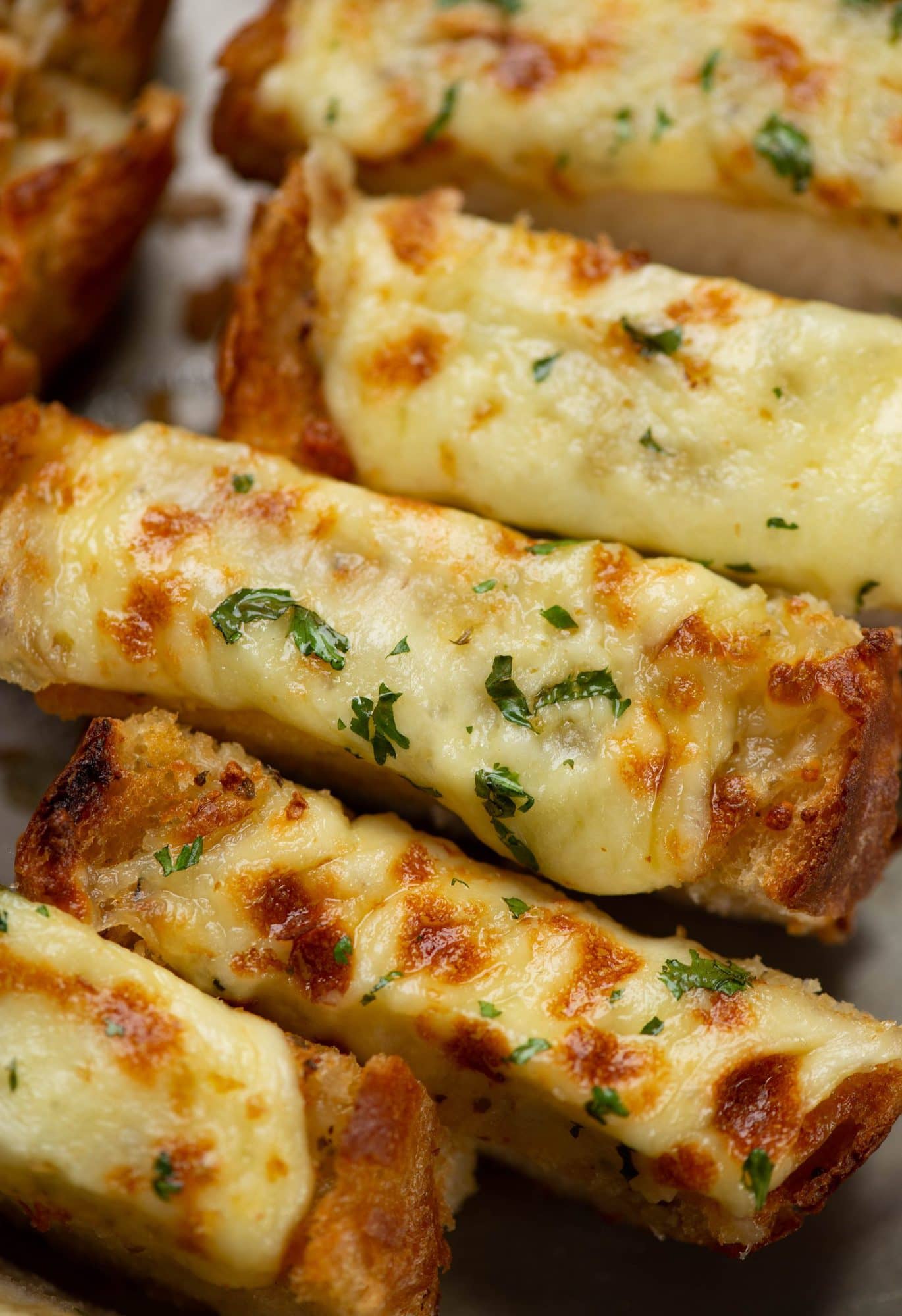 This recipe is the quickest and easiest way to make Garlic Bread. Cheesy, garlic-y deliciousness with crunchy edges is perfect to pair with pasta, dunk into soups, or serve as a side dish. 