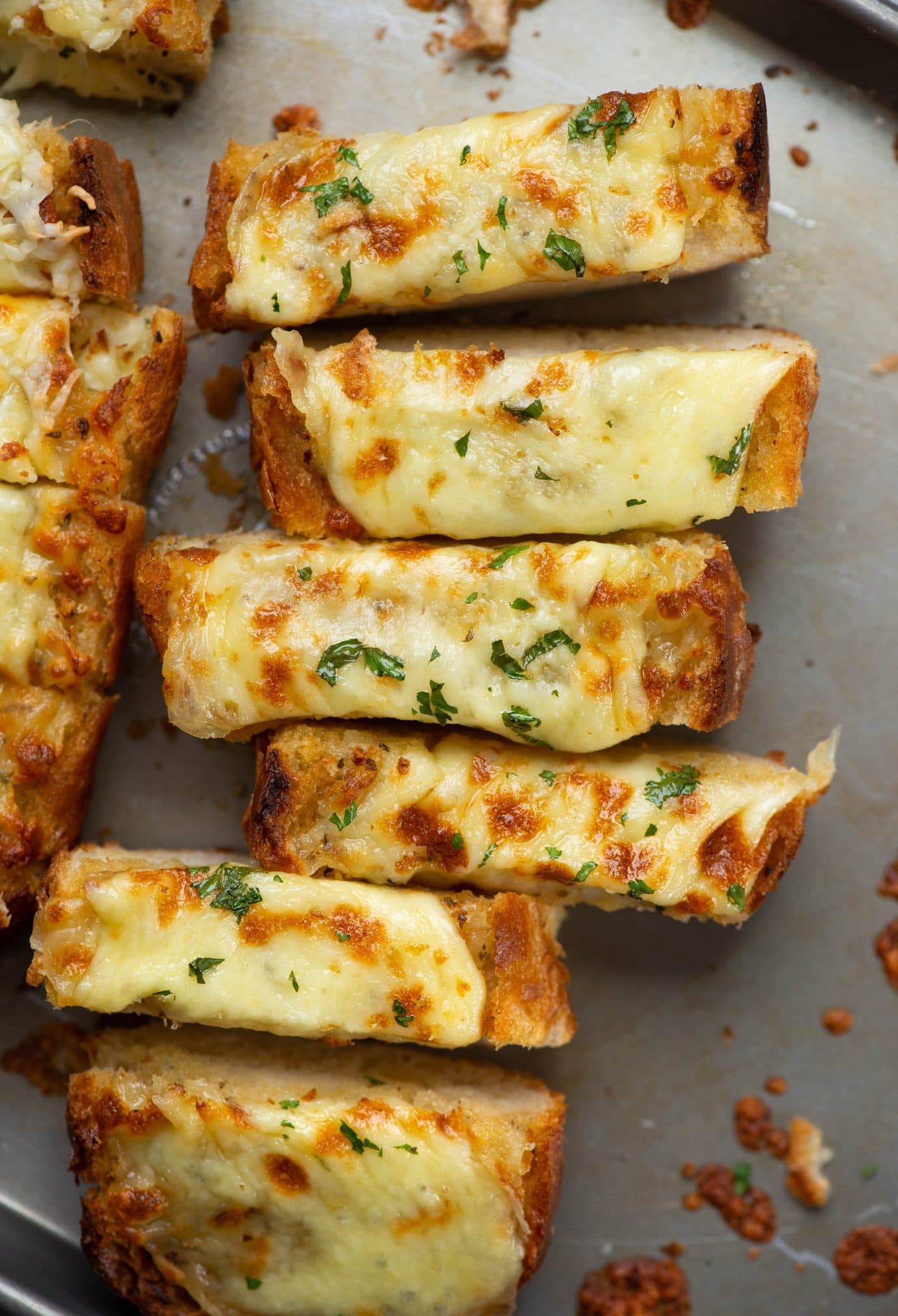 This recipe is the quickest and easiest way to make Garlic Bread. Cheesy, garlic-y deliciousness with crunchy edges is perfect to pair with pasta, dunk into soups, or serve as a side dish. 
