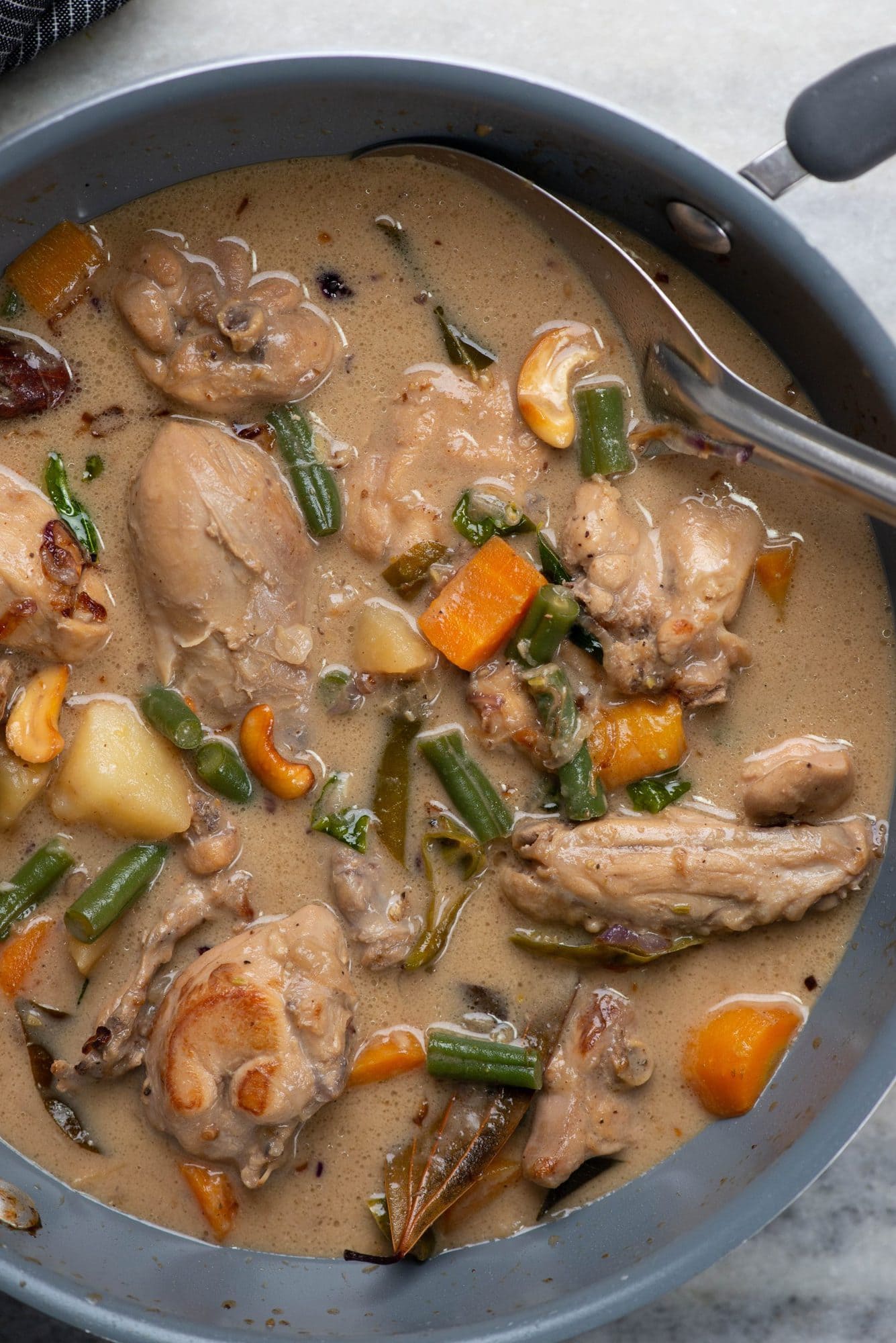 Chicken stew made with kerala style flavors in a pan. 