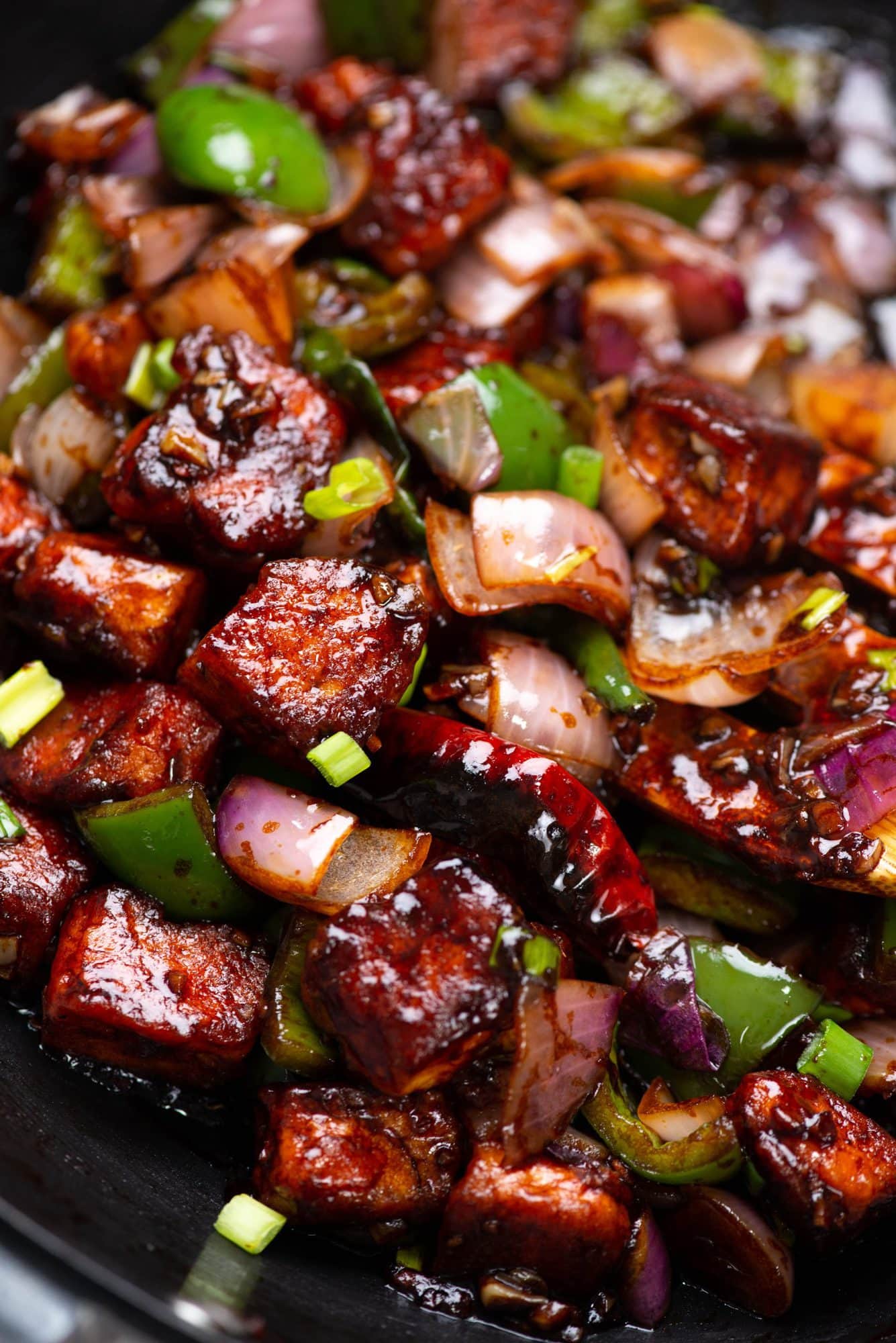 Paneer pieces coated in a batter, deep-fried until crispy, and then tossed along with ginger, garlic, onion and capsicum in an Indo-Chinese savory sauce. 