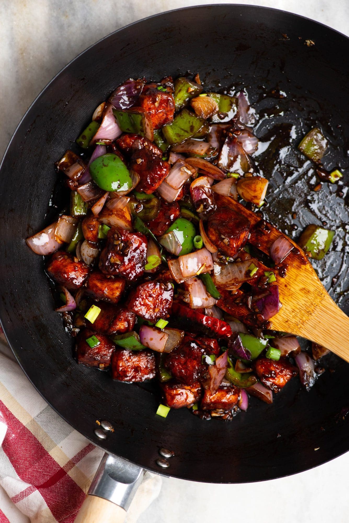 Paneer pieces coated in a batter, deep-fried until crispy, and then tossed along with ginger, garlic, onion and capsicum in an Indo-Chinese savory sauce. 