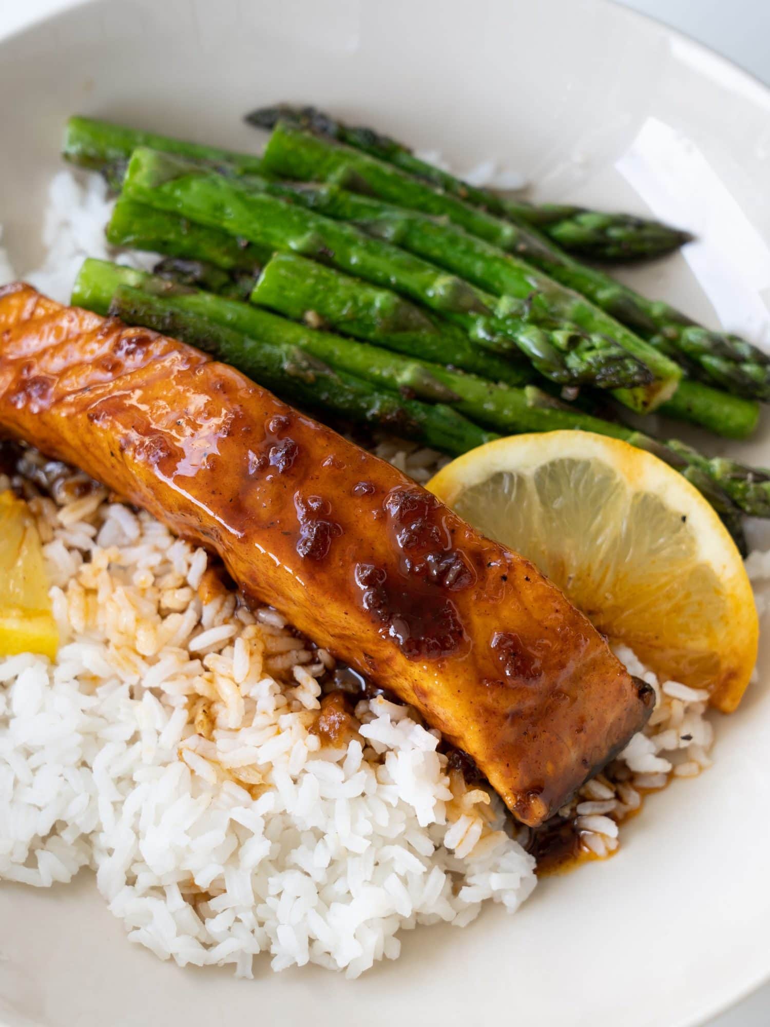 Sticky, sweet, and lemony, this Lemon Honey Glazed Salmon is incredibly delicious. You can make a Salmon Rice bowl with this easy 20 mins recipe and your dinner is sorted.